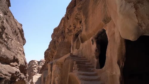 Petra, Jordan. Ancient City Buildings, Caves and Tombs in Sandstone and Desert Canyon, Tilt Down, Fu