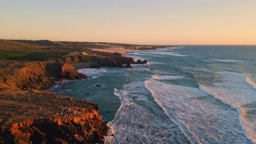 Stunning Aerial View Of Waves Crashing Against Rugged Ocean Cliffs