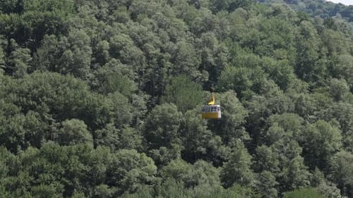Aerial view of cable car in the mountains with forest