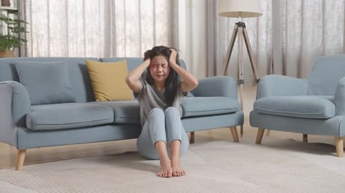 Distressed Woman Crying on Living Room Floor