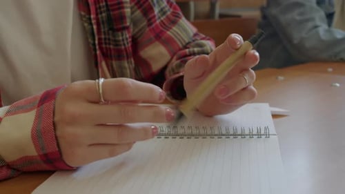 Student Fidgeting with Pen in Classroom