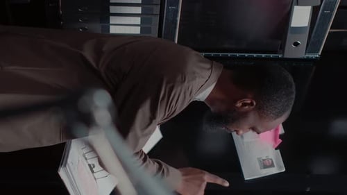Man Looks Over Files in Office