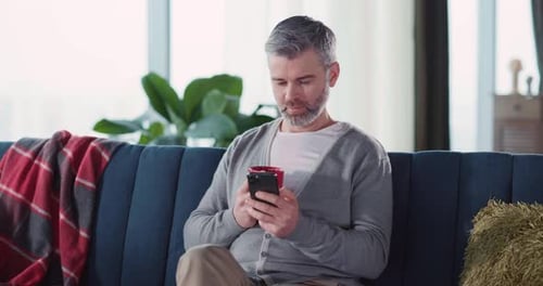 Happy Caucasian Handsome Adult Millennial Staying Home Casual Spending Leisure Afternoon Using