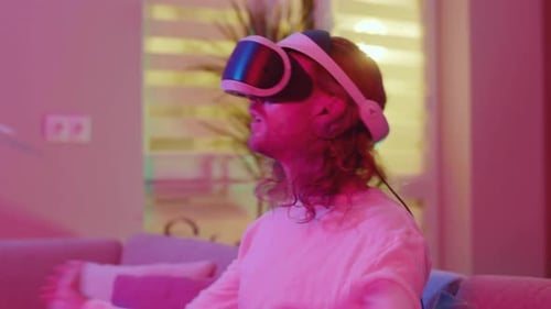 Young Adult Immersed in Virtual Reality at Home