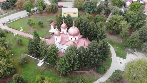 Drone Aerial over orthodox church in Romania sunny countryside