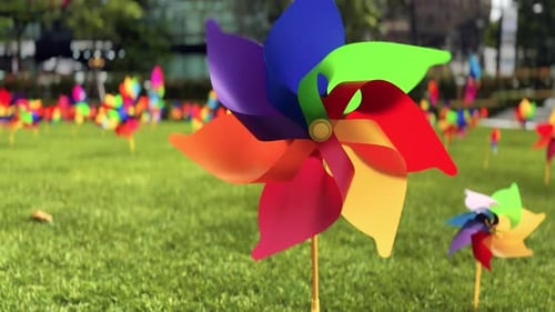 Bright Multicolored Pinwheels Spinning in a City Park