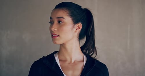 Attractive Young Woman Smiles and Turns to Camera