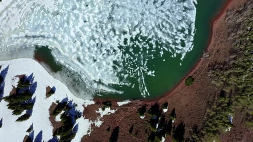 Aerial drone shot of Desolation Lake in Utah’s Big Cottonwood Canyon. Bird's eye view flying over th