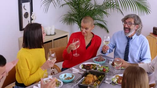 Family and Friends Toasting at Festive Dinner Table