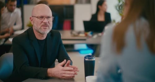 Businessman Discussing with Colleague in Office