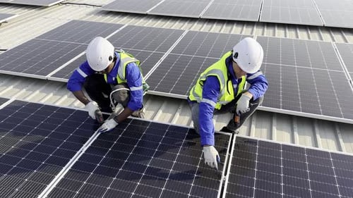 Technician installing solar cell. Installation and maintenance of solar cells on rooftop.