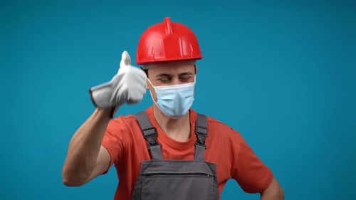 Man in Hard Hat and Mask Gives Thumbs Up