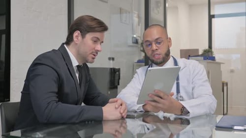 Doctor Explaining Results on Tablet to Patient