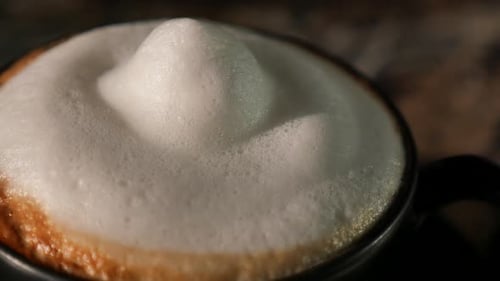 Frothy Coffee Preparation Close Up in a Cafe