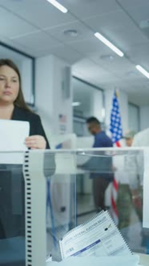 Woman Drops Ballot Into Ballot Box