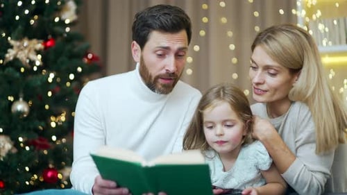 Family Reading a Story at Christmas Time