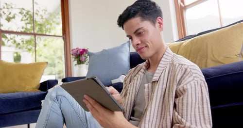 Young Adult Using Tablet Indoors