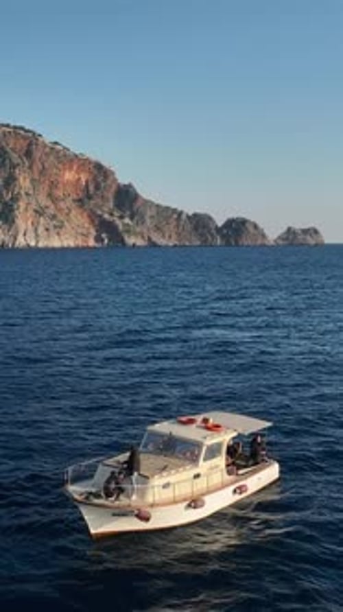 Vertical Video Serenity By the Sea Aerial Perspective of a Fishing Boat on the Mediterranean Coast