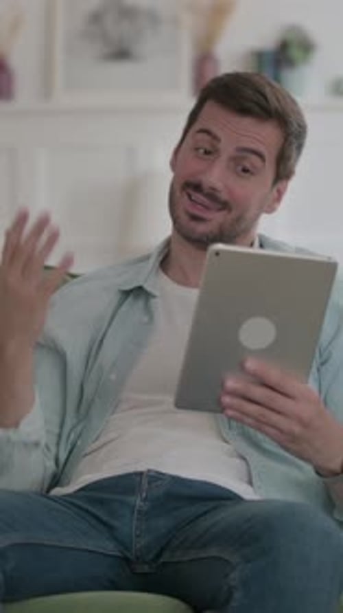 Man Using Tablet Device to Communicate Via Video