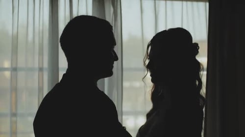 Silhouette of Romantic Couple Embracing Indoors