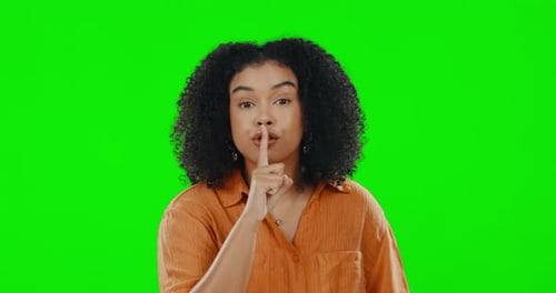 Green screen, face and secret woman for finger on lips, privacy and mystery of noise in studio