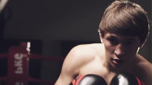 Young Adult Boxer Training in Ring