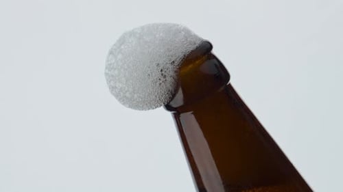 Beer Foam Flowing Bottle Neck in Super Slow Motion Close Up
