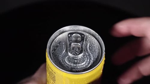 a can of lemonade is being opened