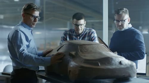 Designers Discuss Car Model at Automotive Studio