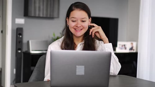 Woman Uses Laptop for Video Call at Home