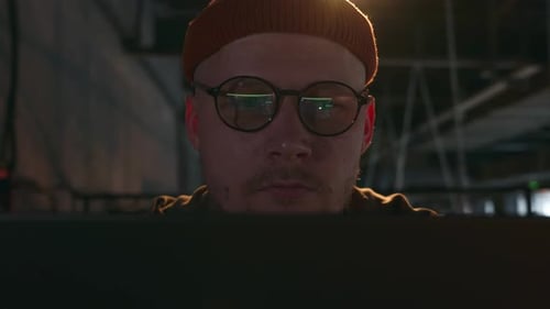 Man working on a computer at night