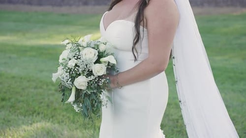 Bride Holds Bouquet of White Flowers