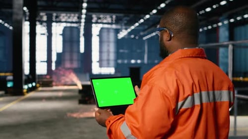 Green Screen Tablet with Worker Managing Operation Tasks Across Factory Floor