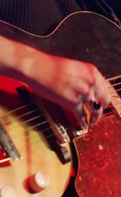 Woman Playing Electric Guitar at Live Concert