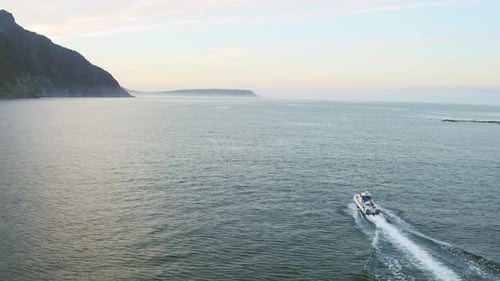 4k drone footage of a boat travelling across the sea