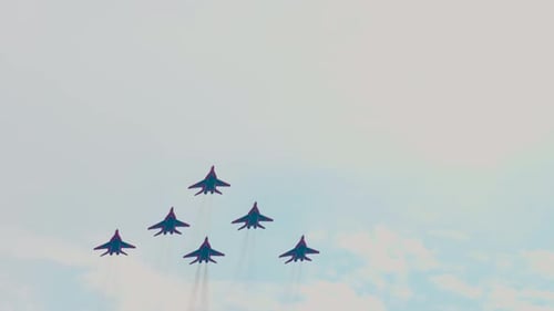 Airplanes Fly in Formation Through Cloudy Sky