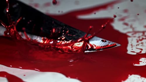 Drops of Blood Fall on the Knife Filmed on a Highspeed Camera at 1000 Fps