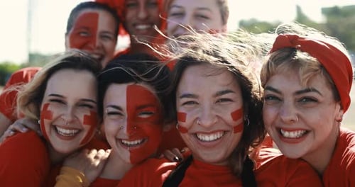 Enthusiastic Group Smiles with Painted Faces