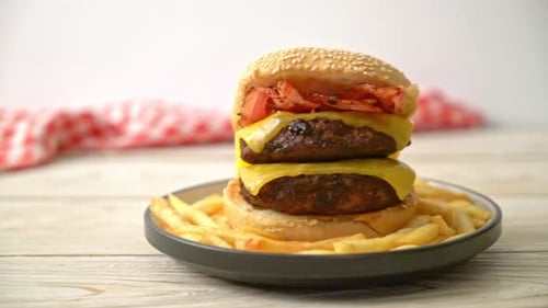 Double Cheeseburger with Crispy Fries on Wooden Table