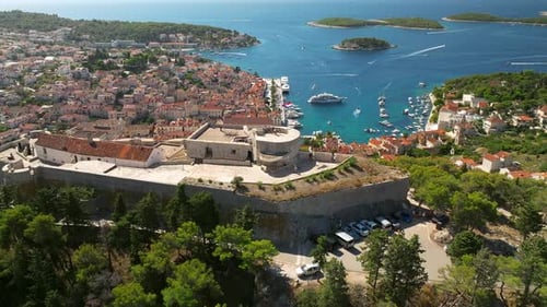 Rotating Aerial view of the castle Tvrđava Fortica above Hvar island in Croatia