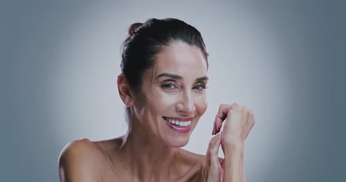 Skincare, mature and face of happy woman in studio, dermatology and wellness with self care by