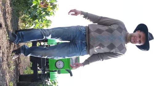 A Young American Farmer Inspects the Plantation of a New Vineyard Vertical Video