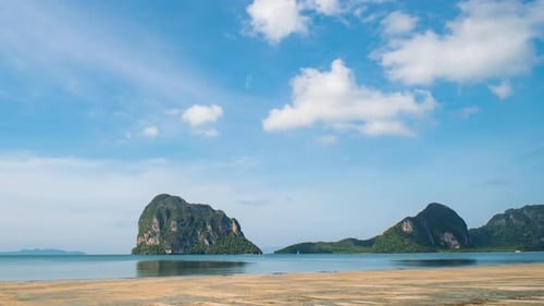 Wunderschöner sonniger Tag an einem tropischen Strand im Zeitraffer, weiße Wolken ziehen über das türkisfarbene Meer.