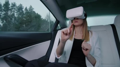 Young Caucasian Woman in Virtual Reality Headset in the Back Seat of a Car