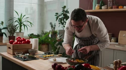 Chef Carefully Plating Food in Sunny Kitchen