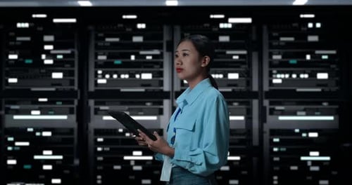 Female Technician with Tablet in Data Center