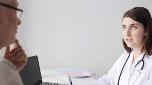 Medicine, Age, Health Care And People Concept - Senior Man And Doctor Meeting In Medical Office A...