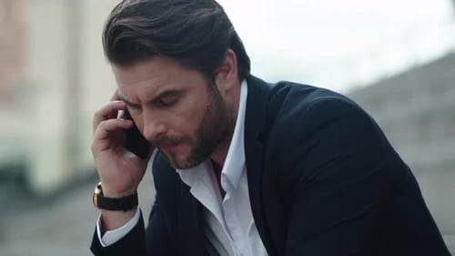 Stressed Business Man Having Conversation on Smartphone at Street. Serious Professional Calling