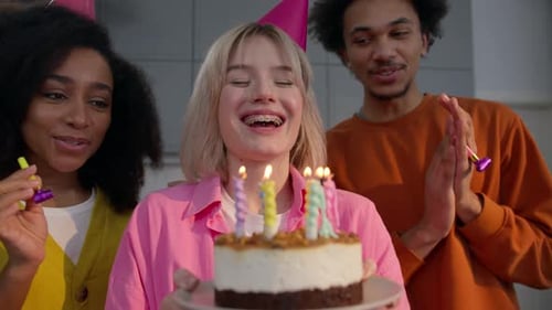 Friends Celebrate Birthday with Cake and Party Blowers