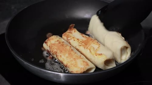 Frying Stuffed Pancakes with Cottage Cheese in Pan with Hot Oil Turning Over Delicious Homemade